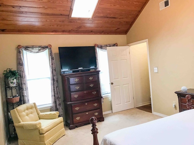 carpeted bedroom featuring wooden ceiling and vaulted ceiling with skylight