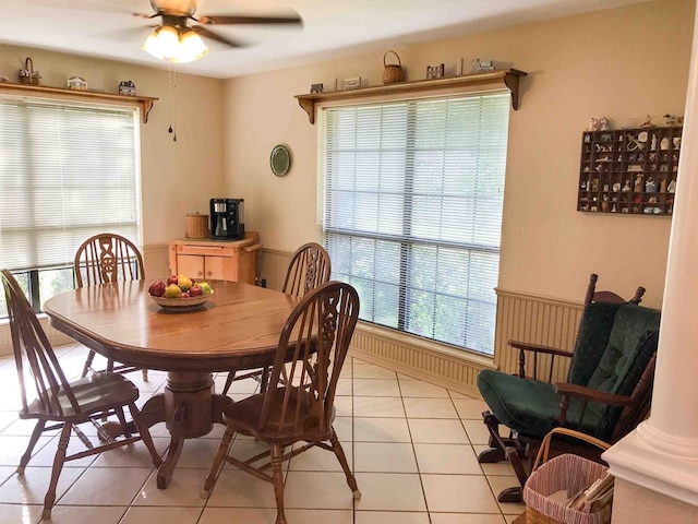 tiled dining space with ceiling fan