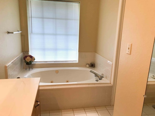 bathroom with vanity, tile patterned flooring, and a relaxing tiled tub