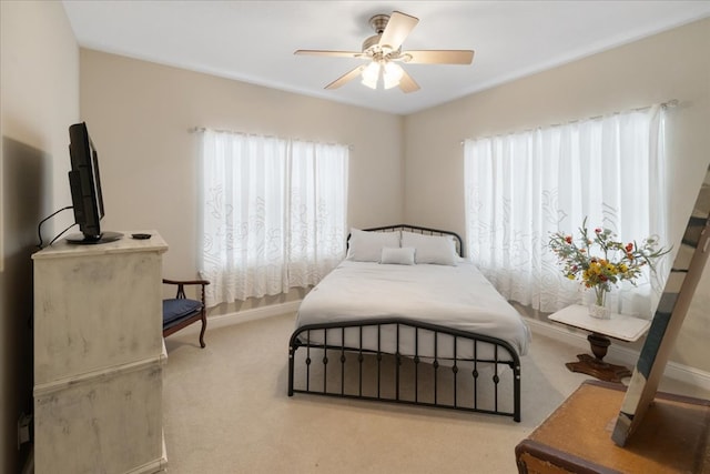 bedroom featuring light carpet and ceiling fan