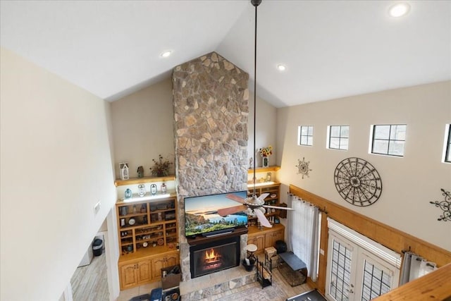 living room with light hardwood / wood-style floors and high vaulted ceiling