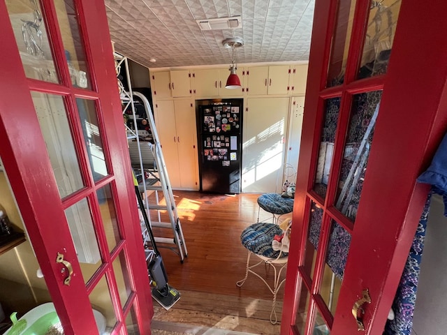 interior space featuring brick ceiling and hardwood / wood-style flooring