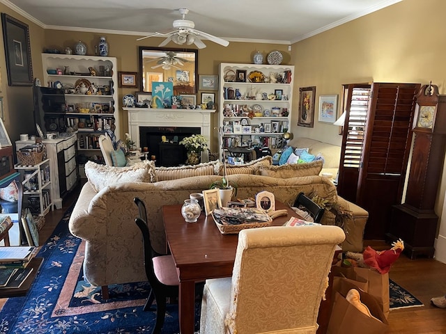 living room featuring hardwood / wood-style flooring, ceiling fan, and ornamental molding