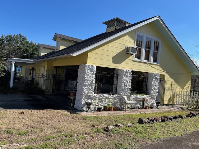 view of home's exterior with an AC wall unit