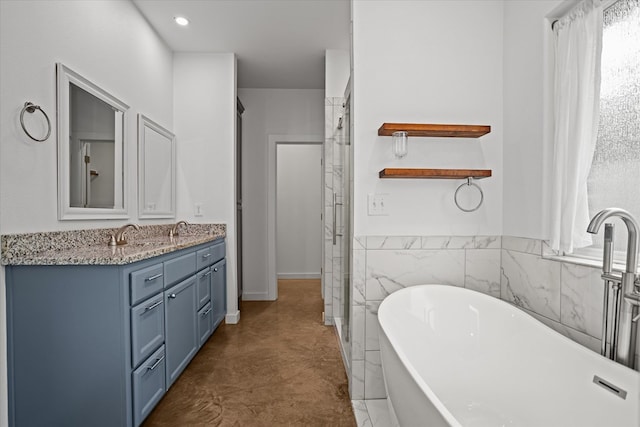 174 Cedar Hill Loop, Lufkin, TX 75904 - full bath featuring double vanity, a freestanding bath, a shower stall, finished concrete flooring, and tile walls