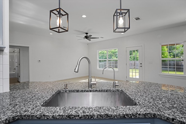 174 Cedar Hill Loop, Lufkin, TX 75904 - kitchen with a sink, dark stone counters, a ceiling fan, healthy amount of natural light, and recessed lighting