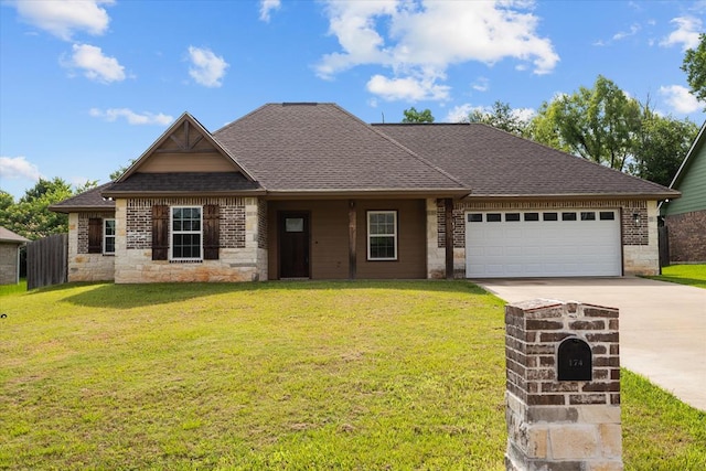 174 Cedar Hill Loop, Lufkin, TX 75904 - view of front facade featuring concrete driveway, a garage, brick siding, a shingled roof, and stone siding