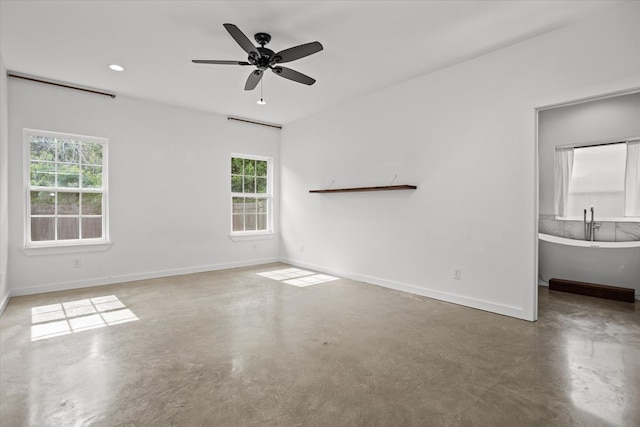 174 Cedar Hill Loop, Lufkin, TX 75904 - spare room with concrete flooring, healthy amount of natural light, a ceiling fan, and baseboards
