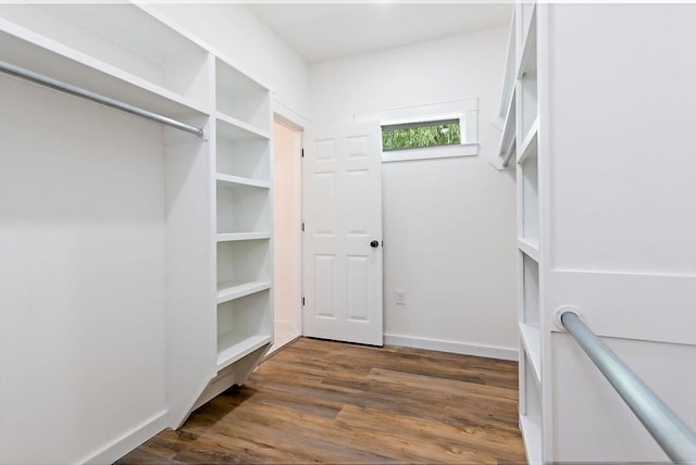 spacious closet with dark wood-type flooring