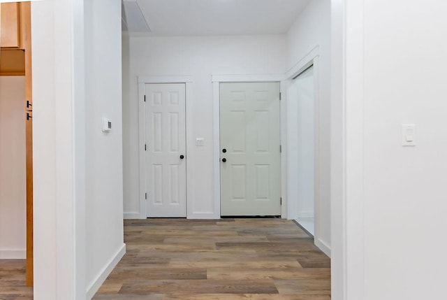 corridor with light wood-type flooring