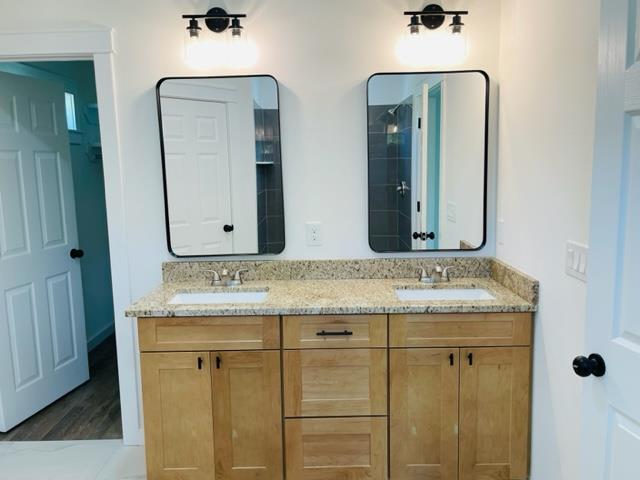 bathroom with hardwood / wood-style floors and vanity