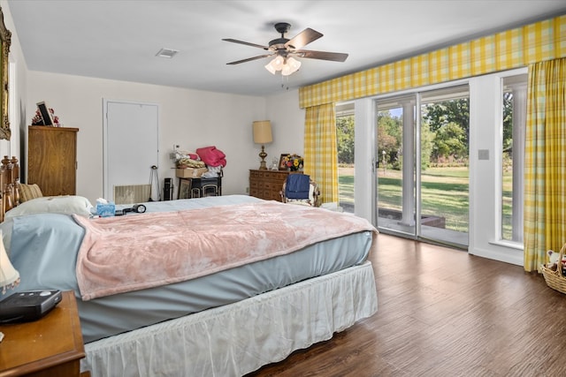 bedroom with access to outside, ceiling fan, and dark wood-type flooring