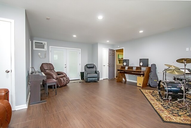 office featuring french doors, a wall mounted AC, and dark wood-type flooring