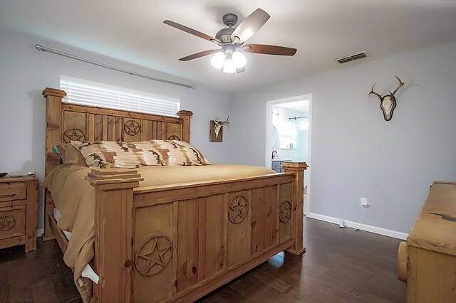 bedroom featuring connected bathroom, ceiling fan, and dark wood-type flooring