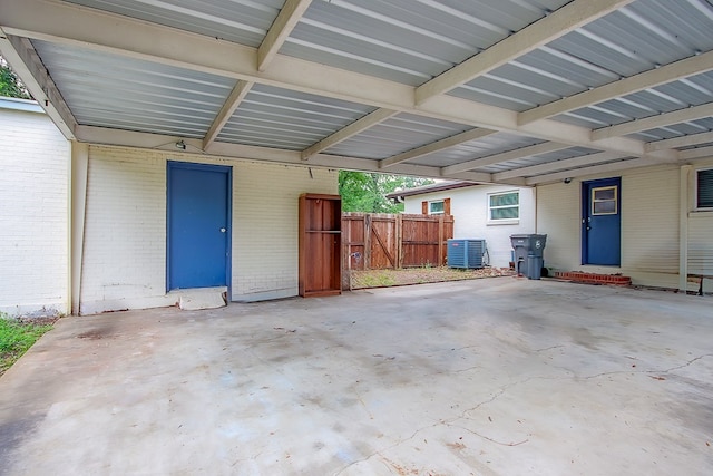 garage with a carport and central AC