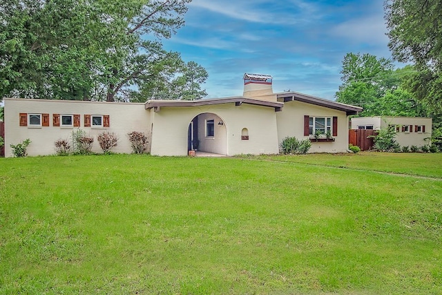 rear view of property featuring a yard