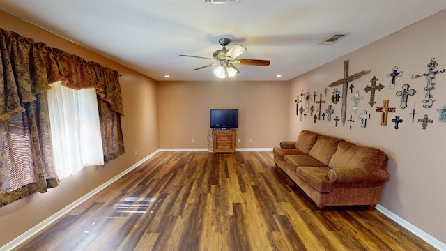 living room with ceiling fan and dark hardwood / wood-style flooring