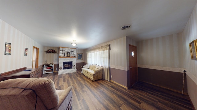 living room featuring dark hardwood / wood-style floors and a fireplace