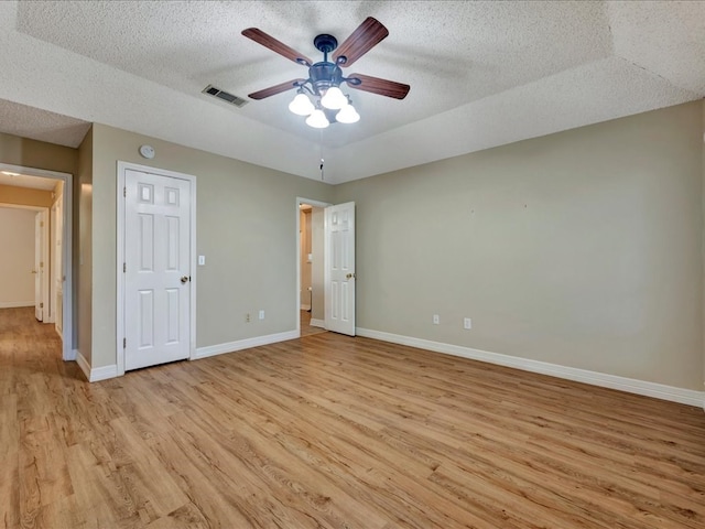 unfurnished bedroom featuring ceiling fan, light hardwood / wood-style flooring, and a textured ceiling