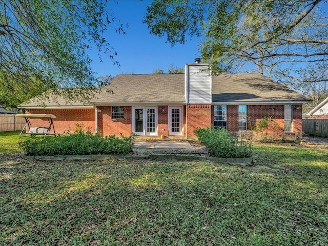 back of house featuring a lawn