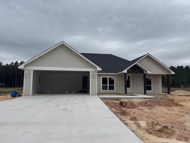 view of front facade featuring board and batten siding, concrete driveway, and a garage