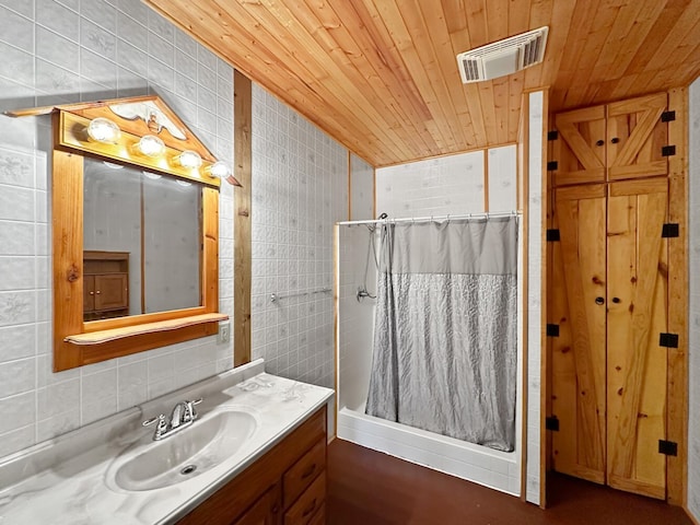 bathroom featuring vanity, wood ceiling, tile walls, and walk in shower