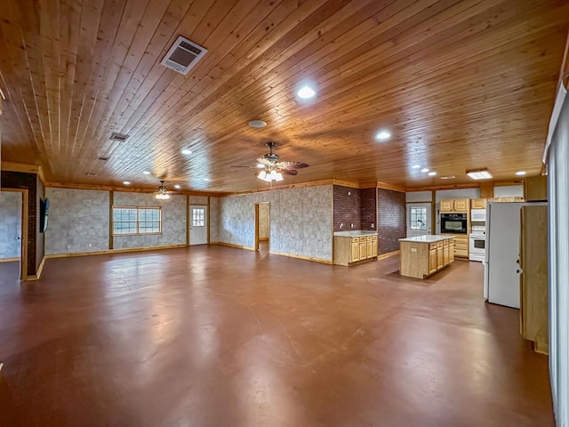 unfurnished living room featuring concrete flooring, ceiling fan, and wood ceiling