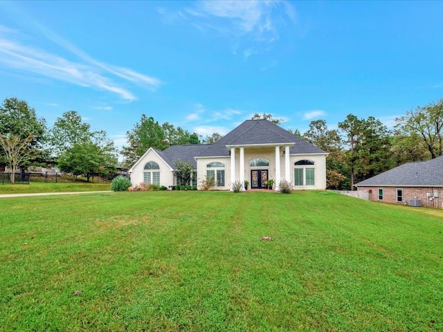 view of front of property featuring central AC unit and a front lawn