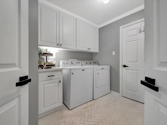 laundry area with cabinets, light parquet flooring, washer and dryer, and crown molding