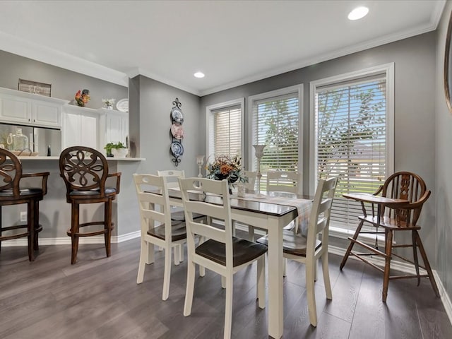 dining space with crown molding and dark wood-type flooring