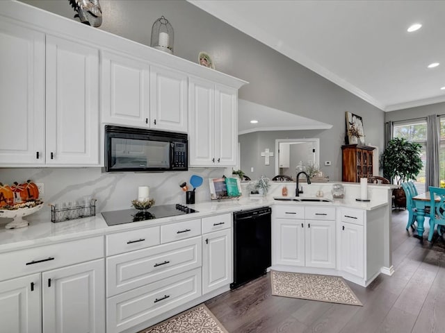 kitchen featuring white cabinetry, sink, dark hardwood / wood-style floors, kitchen peninsula, and black appliances