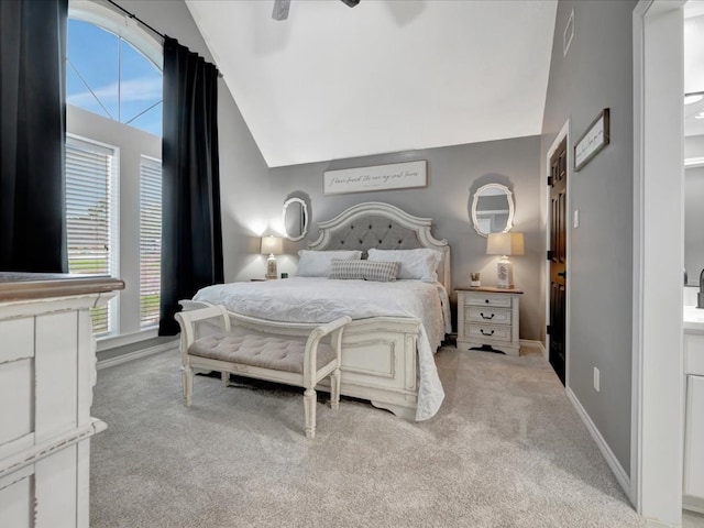 bedroom with ceiling fan, light colored carpet, and vaulted ceiling