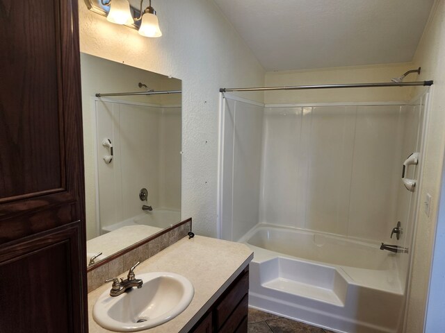 bathroom featuring tile patterned floors, vanity, a textured ceiling, and tub / shower combination