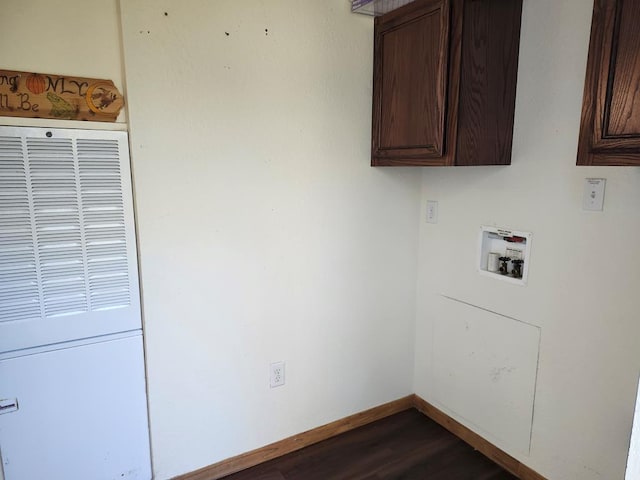 laundry room featuring washer hookup, dark hardwood / wood-style flooring, and cabinets