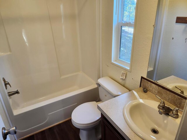 full bathroom with vanity, hardwood / wood-style flooring, toilet, and plenty of natural light