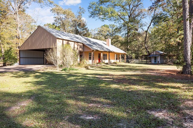 view of front facade with a front lawn and a carport