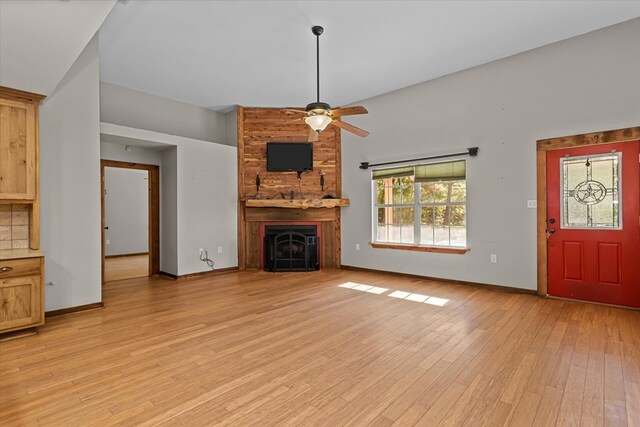 unfurnished living room featuring ceiling fan, light hardwood / wood-style floors, and a fireplace