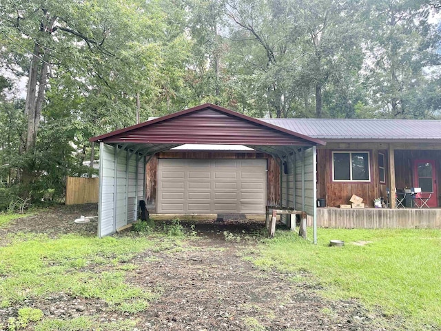 view of front of home featuring a carport, a front yard, metal roof, a garage, and driveway