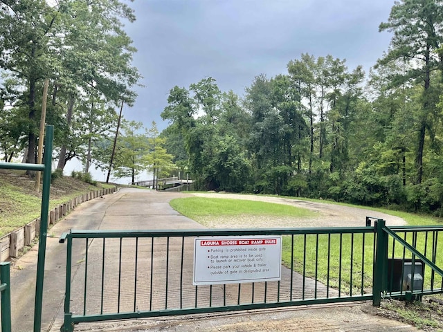 view of gate featuring a yard