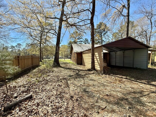 view of front of property with a carport and a garage