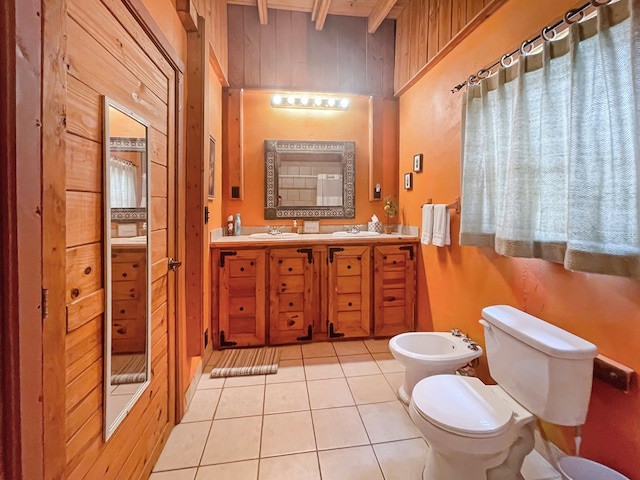 full bath featuring a sink, wooden walls, toilet, a bidet, and tile patterned flooring