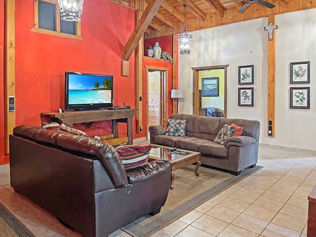 living area with a ceiling fan, tile patterned floors, wood ceiling, beamed ceiling, and baseboards