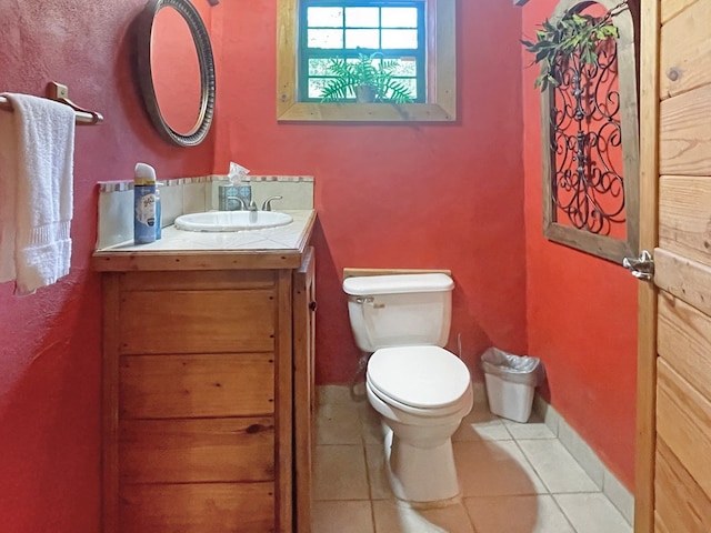 bathroom featuring tile patterned floors, vanity, and toilet