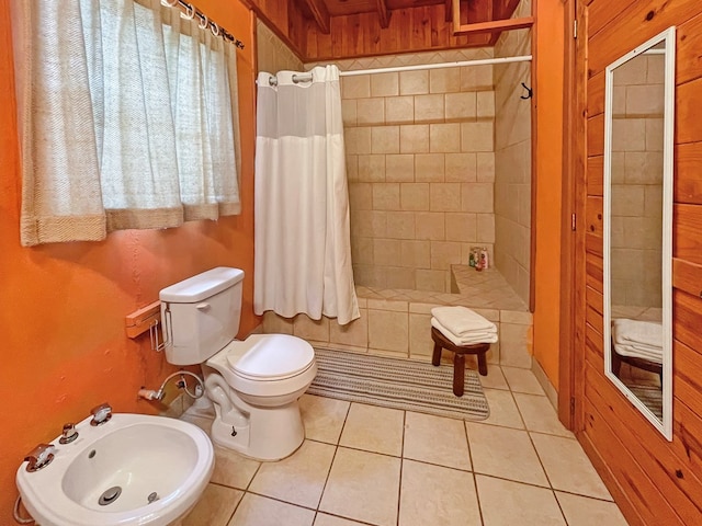 full bathroom featuring a bidet, tile patterned flooring, a stall shower, and toilet