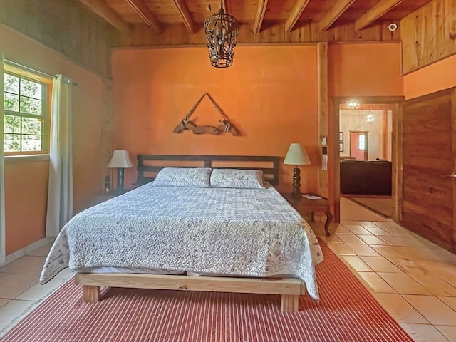 bedroom with wooden ceiling, wood walls, beam ceiling, and light tile patterned flooring