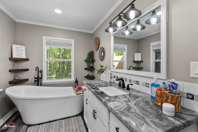 538 Timpson St, Timpson, TX 75975 - full bath featuring a freestanding tub, crown molding, vanity, and wood finished floors
