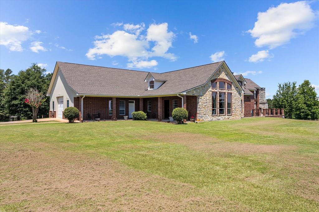 view of front of house with a garage and a front lawn