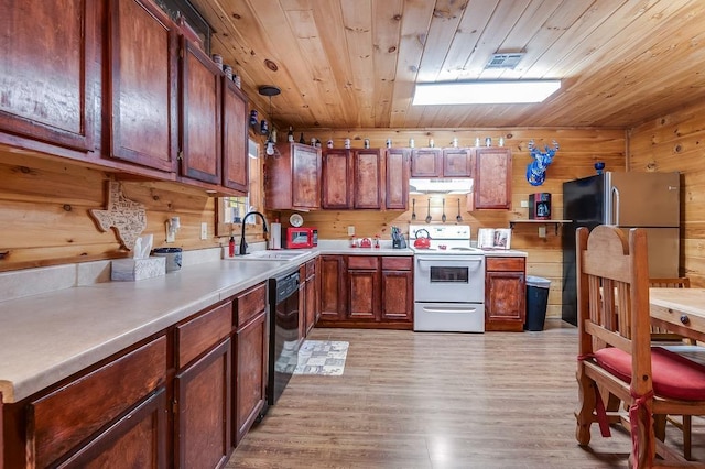 kitchen with electric stove, wooden walls, sink, and dishwasher