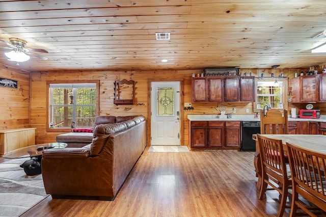 living room featuring ceiling fan, light wood-type flooring, wood ceiling, and wood walls