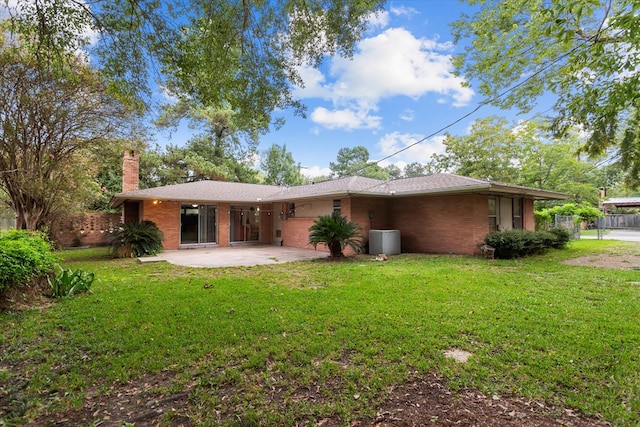 back of property featuring a yard and a patio